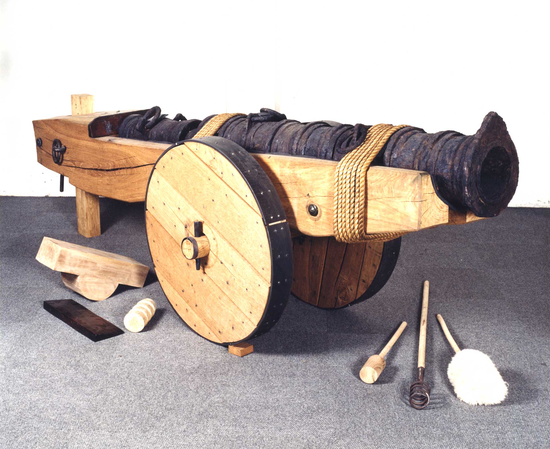 A large metal cannon on a wooden support and wheels