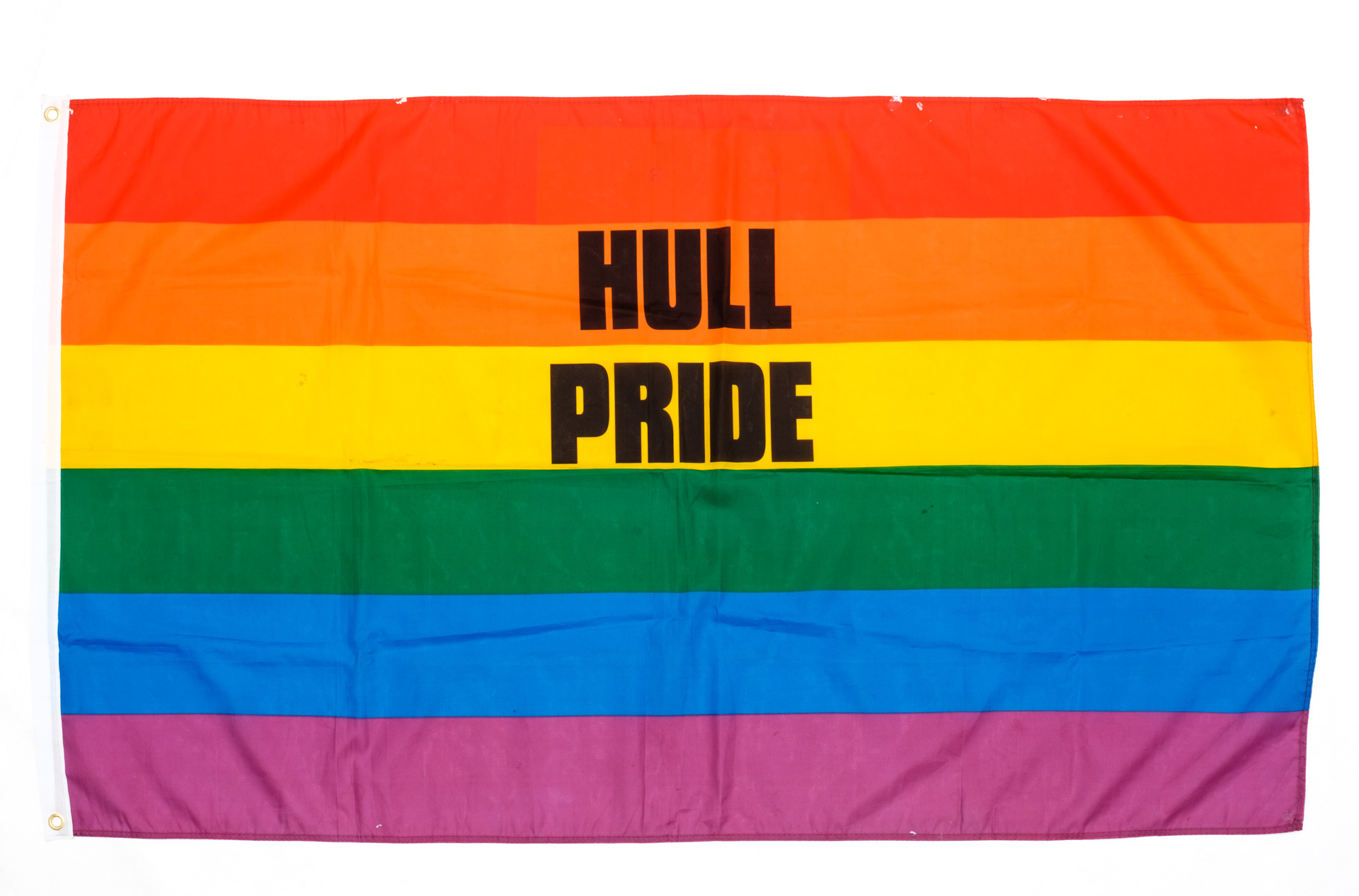 A rainbow flag with Hull Pride written on it in black lettering