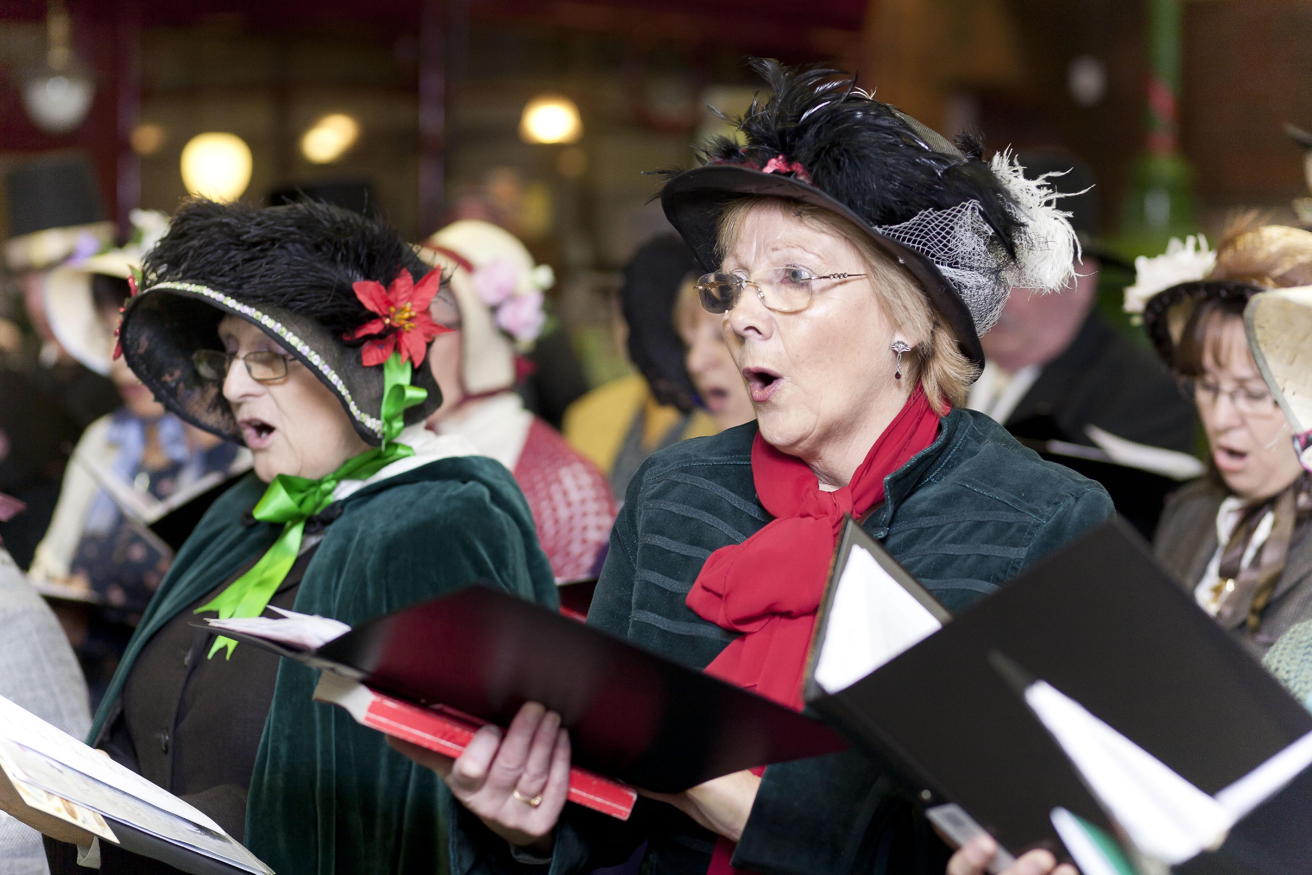 A choir dressed in Victorian outfits