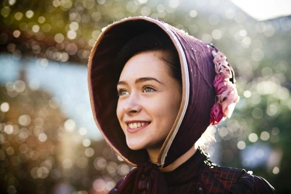 A woman wearing a maroon bonnet