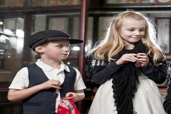 A boy and girl in Victorian costume