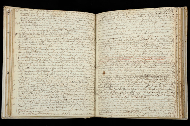 A book containing handwritten writing in ink.